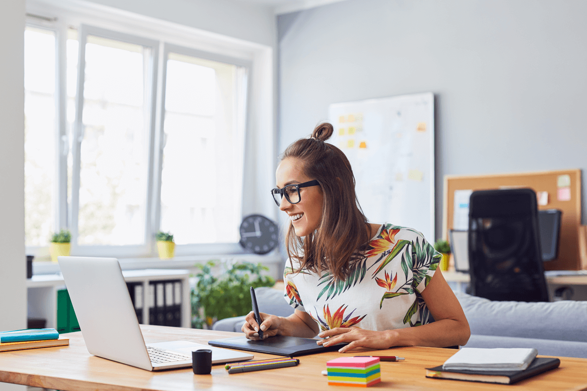 Happy woman designer at work. Data-driven design is the designer's dream.